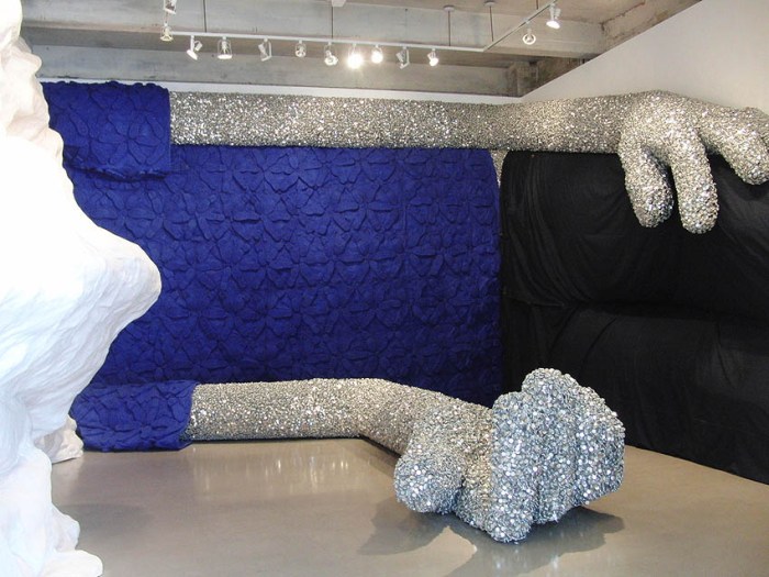 Everyman full-gallery sculpture, cool art installation with bottle caps, shoes, paint brushes