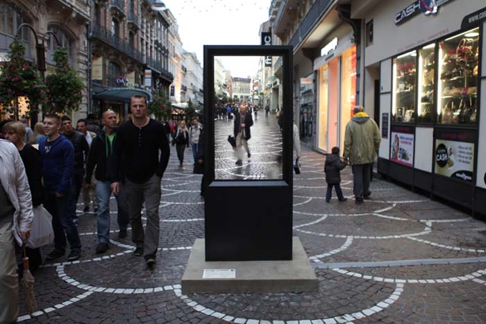 Video street installation in France by artist Thierry Fournier titled A+. Video of same street 24 hours earlier tricking viewers
